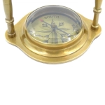 Brass clock on an arch with a compass