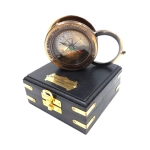 Compass with a magnifying glass in a wooden box