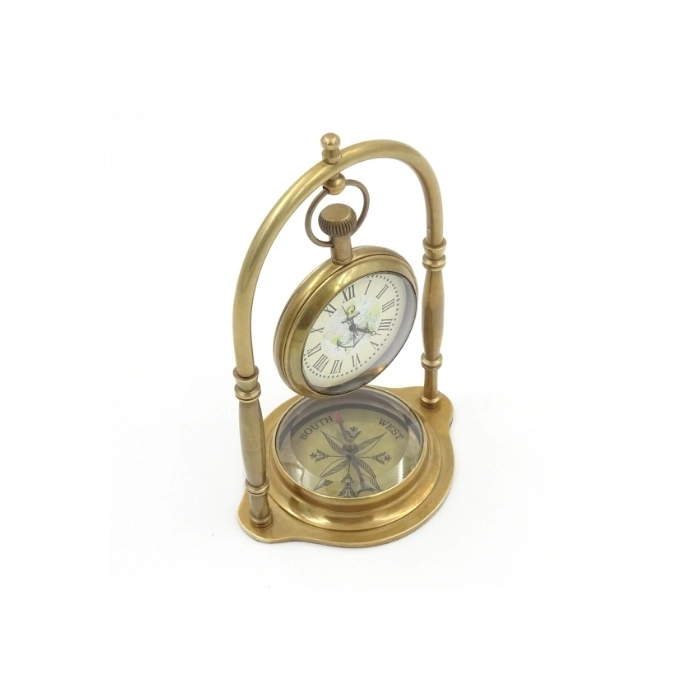 Brass clock on an arch with a compass