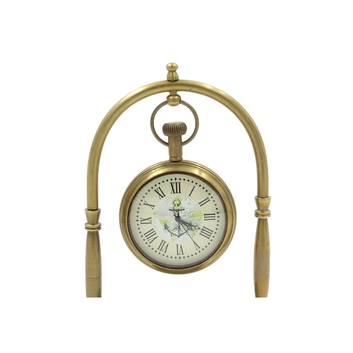 Brass clock on an arch with a compass