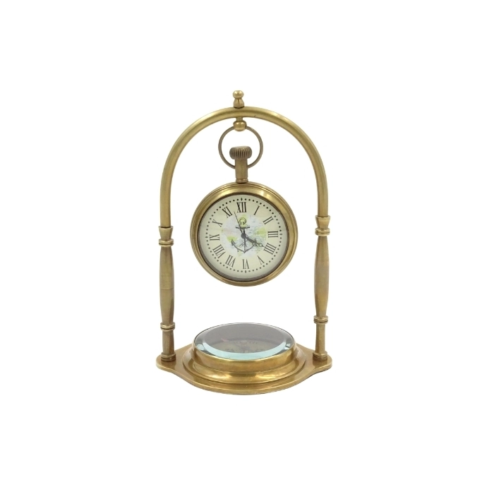 Brass clock on an arch with a compass